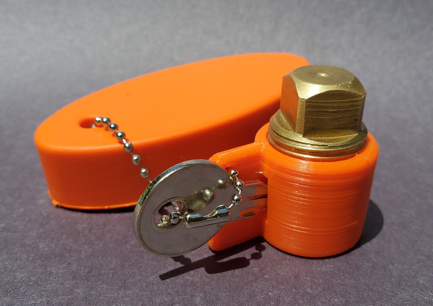 PlugKeyper (Orange) - boat drain plug reminder. Designed for a 1/2 garboard drain plug.